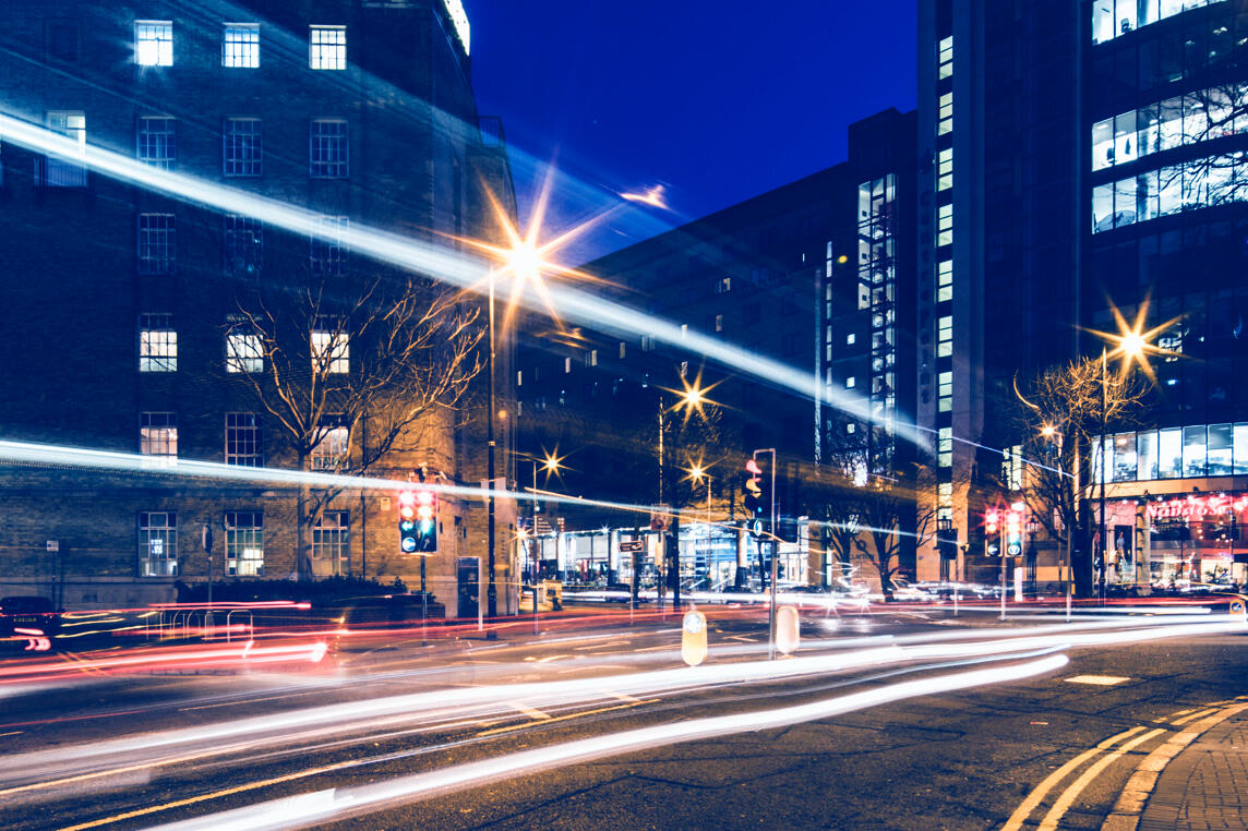 May Street area of Belfast city centre at dusk, with light trails from passing traffic